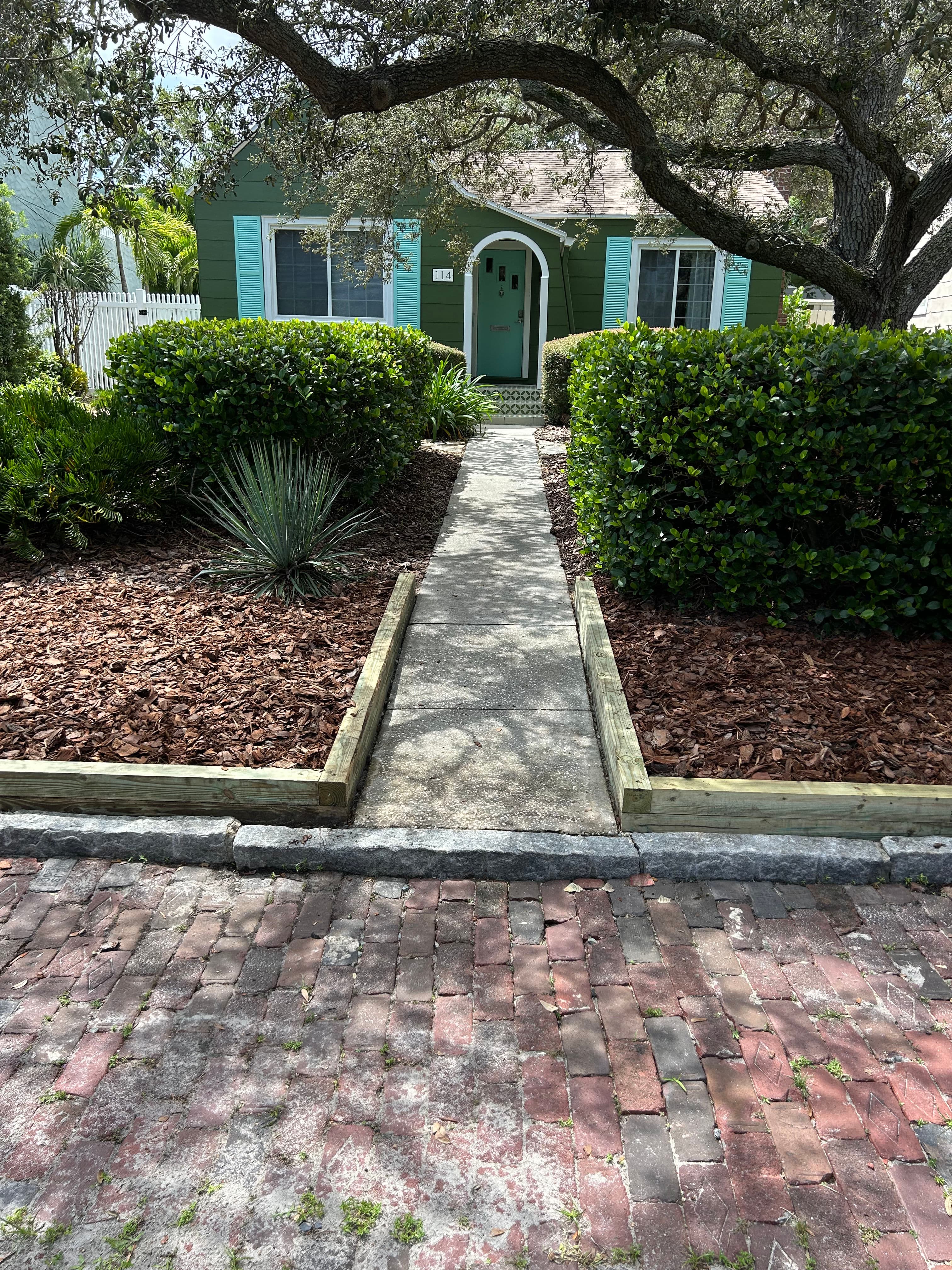 Project Enhancing Curb Appeal with New Wooden Borders and Fresh Mulch Installation image