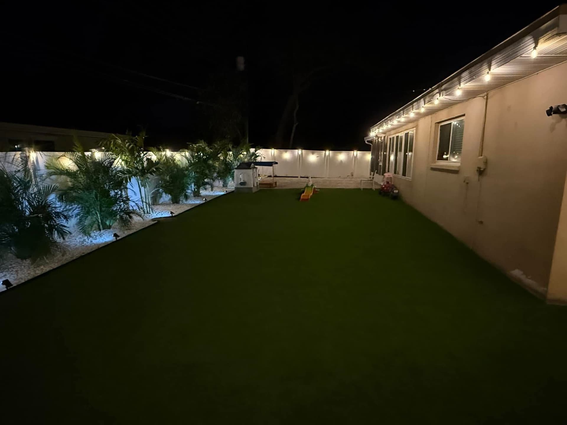 Gallery photos for Backyard Oasis with Artificial Turf and Elegant Lighting: Image #1